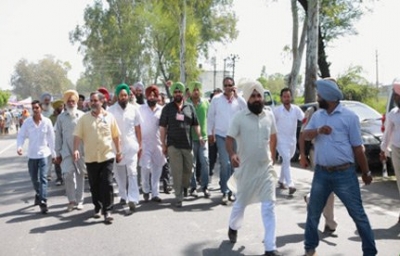 Walks with Bhupinder Sidhu, Garry Grewal, and other supporters en route to Khatkar Kalan